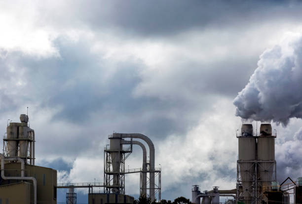 Clouds of dark smoke from industrial chimneys, background with copy space, full frame horizontal composition