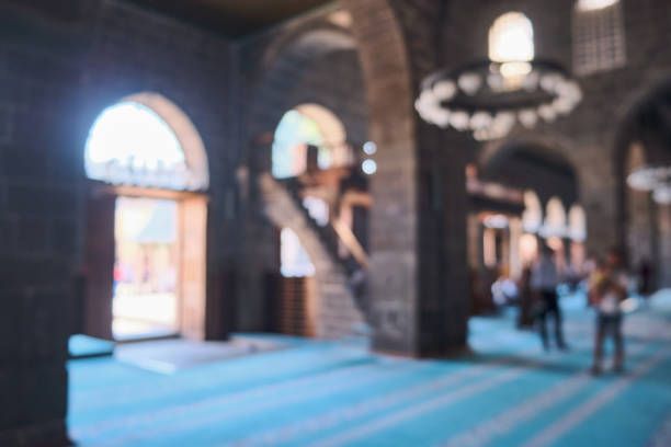 Blurred Interior of mosque Blurred interior of mosque. Unrecognizable people at mosque grand mosque photos stock pictures, royalty-free photos & images
