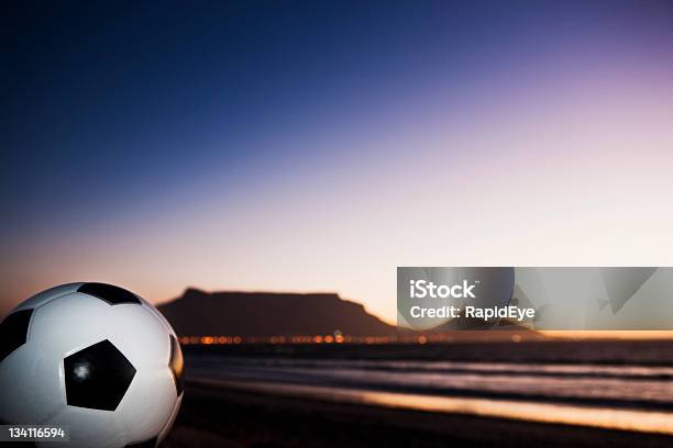 Soccer Ball Against Silhouetted Table Mountain Stock Photo - Download Image Now - 2010, Africa, Beach