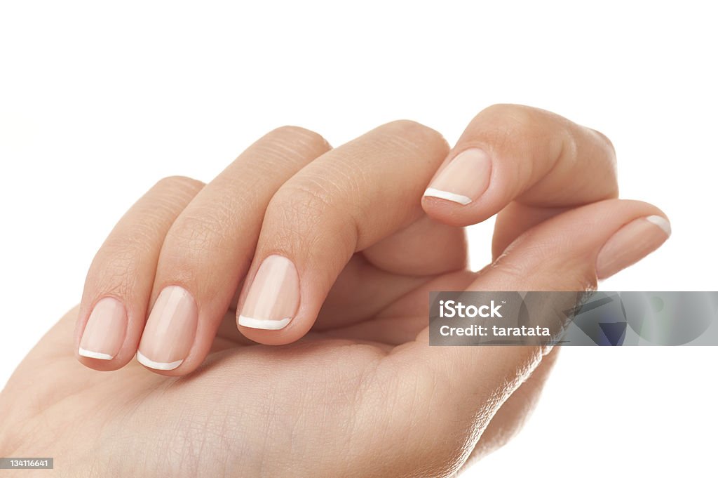 French manicure close-up Close-up of woman’s hand with French manicure isolated on white. Fingernail Stock Photo