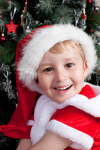 Young caucasian boy dressed in santa hat stock photo