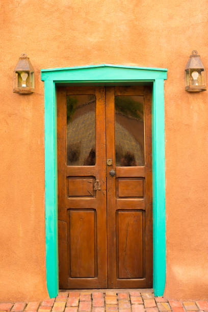 istock Santa Fe Style: Adobe Wall, Antique Door Rimmed in Turquoise 1341172318