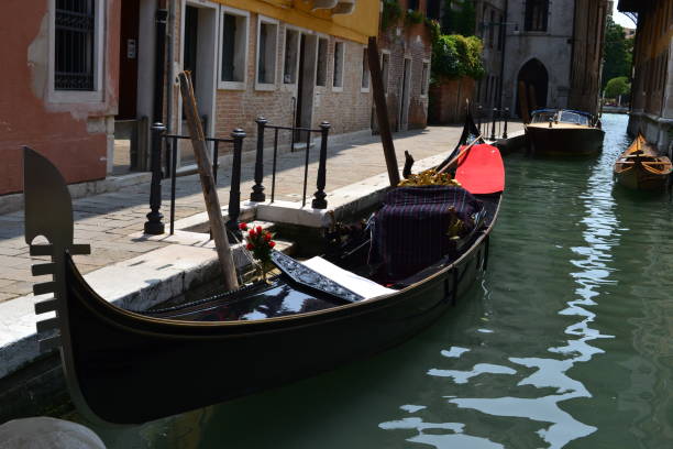 istock gondola parked on a dock on a canal in venice 1341174401