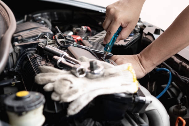 istock Car technician man use screwdriver remove bolt in engine room service and maintenance concept 1341176050