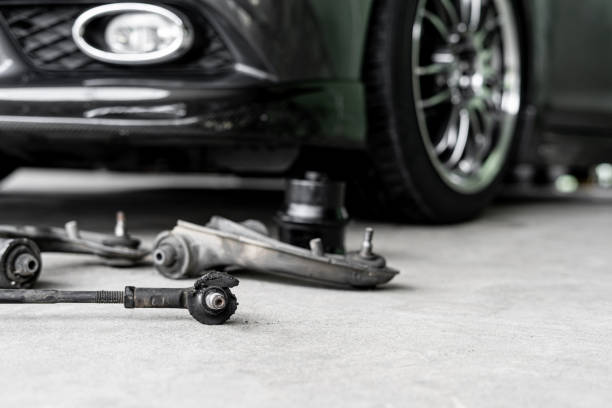 old ball joint of steering rack arm car and steering spare parts on the floor of garage repair car concept - knuckle imagens e fotografias de stock