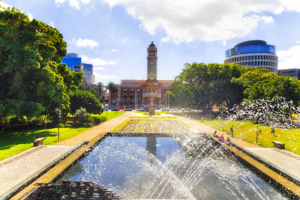 Newcastle town hall square drops Public Town Hall building in city of Newcaslte, Australia with city park, square and water pool with fountain on a sunny summer day. newcastle australia stock pictures, royalty-free photos & images
