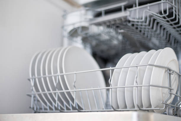 istock White flat plates are loaded into the dishwasher 1341178093