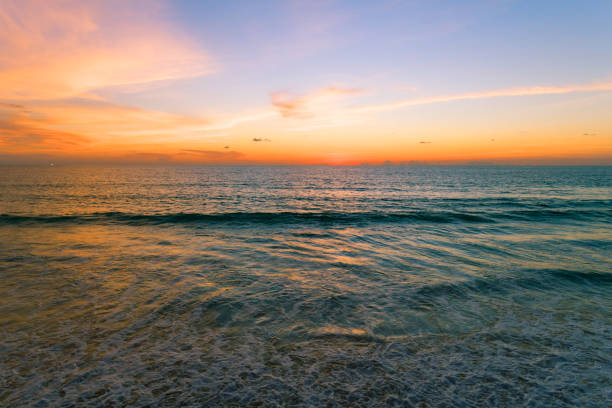 istock Aerial view Beautiful view sunset over sea surface beautiful wave Amazing light sunset or sunrise sky over sea beach with wave crashing on sandy shore 1341184258