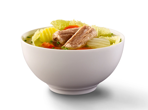 Pork rib soup with the boiled vegetables on the white background