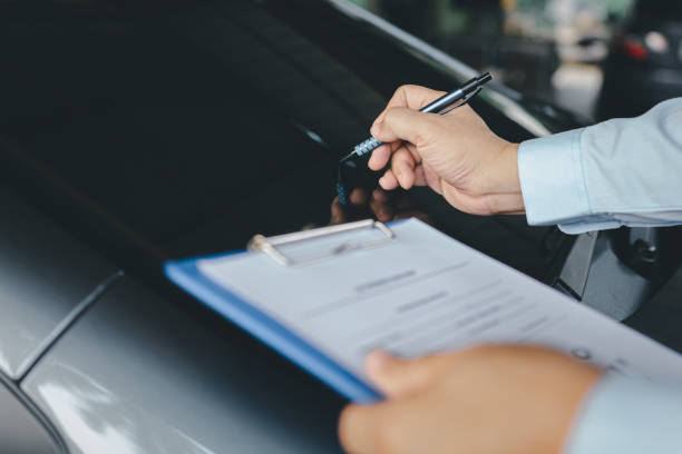 istock Insurance agent check broken of car glass and write on clipboard while examining car after accident claim 1341193743