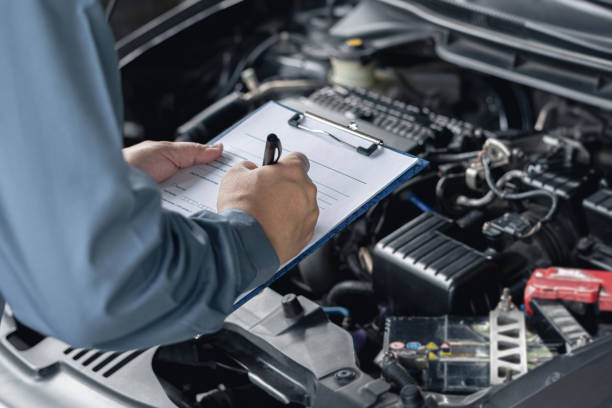 istock Close up hand car service staff check engine malfunctions and mistake check list in engine room : Car service concept 1341196594