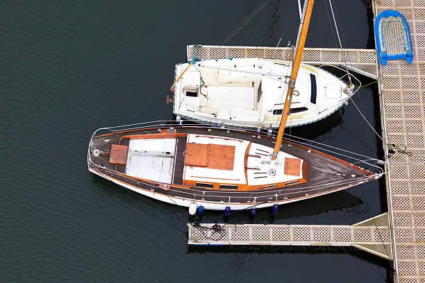 Wooden sailing-boats near pier from above