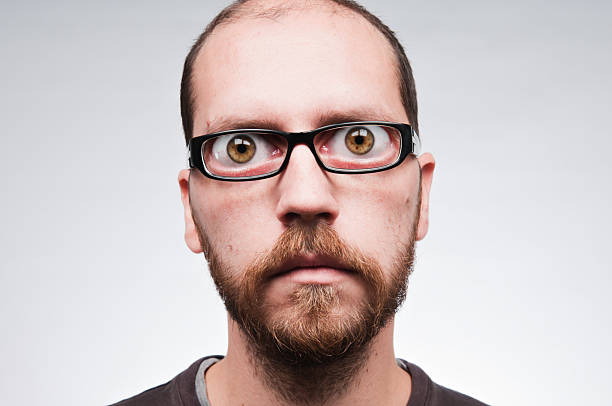 Man with glasses. Eyeglass magnification stock photo