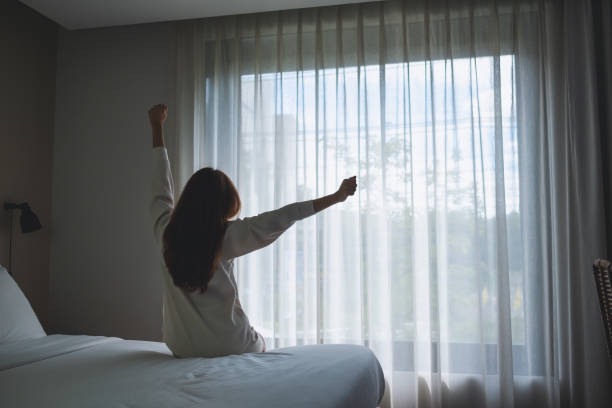 istock a woman do stretching after waking up in bedroom 1341207548
