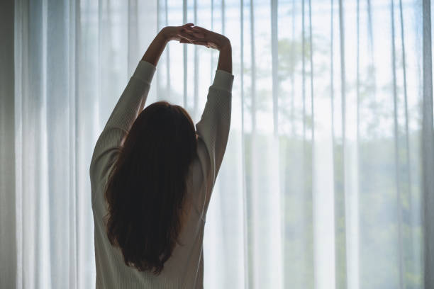 istock a woman do stretching after waking up in bedroom 1341207568