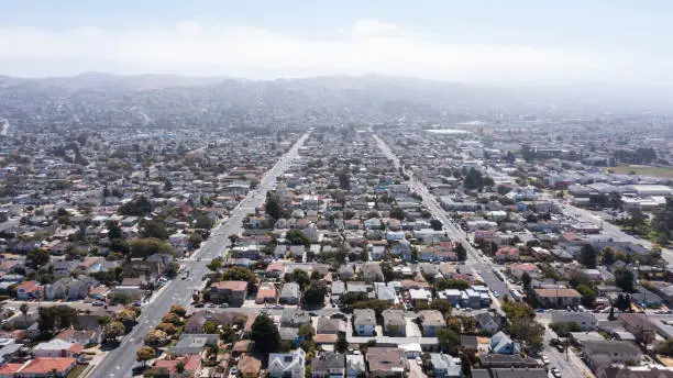 Daytime aerial view of dense residential sprawl in the Bay Area city of Richmond, California, USA.