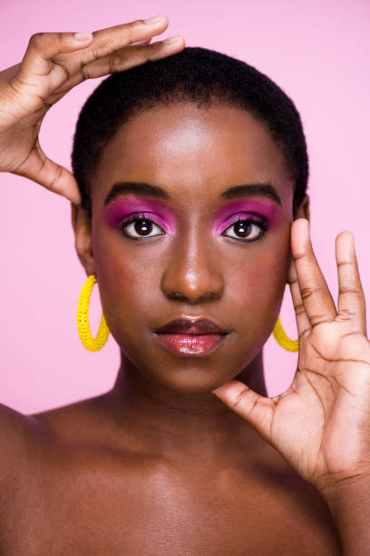 istock African woman with bright make up and hands framing face 1341209360