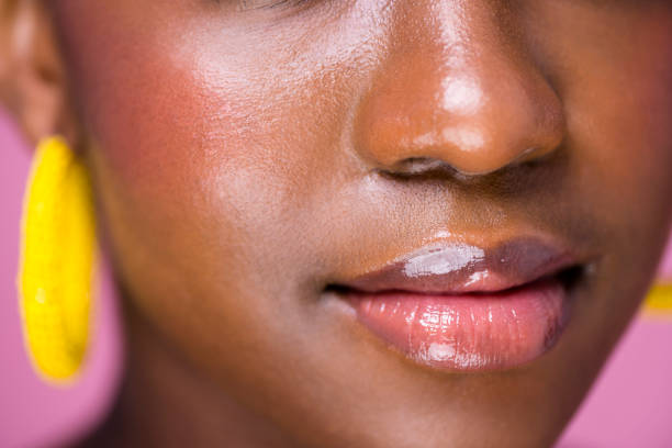 cerrar labios brillantes joven africana - gloss de labios fotografías e imágenes de stock