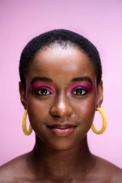 istock Confident portrait African woman with pink glossy make up in studio 1341209400