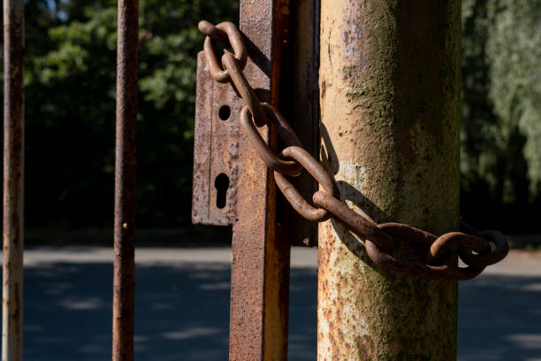 istock padlocked old rusty Metal chain on a gate. 1341211943