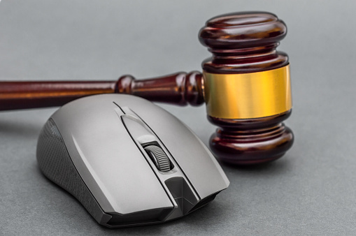 Computer mouse with judge gavel. Close up.