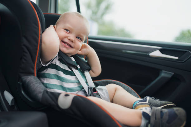 istock Cute smiling baby in a car seat 1341213519