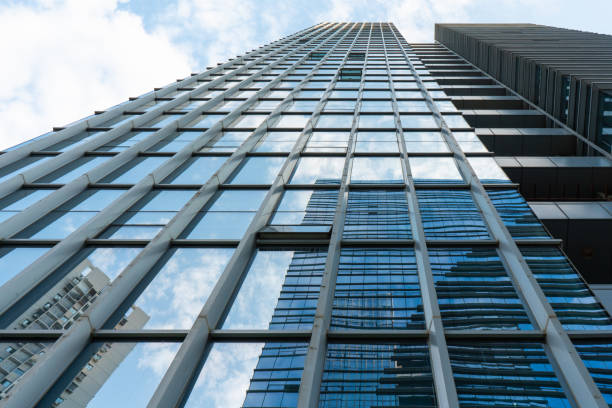 istock Bottom view of modern architecture under blue sky and white clouds 1341216734