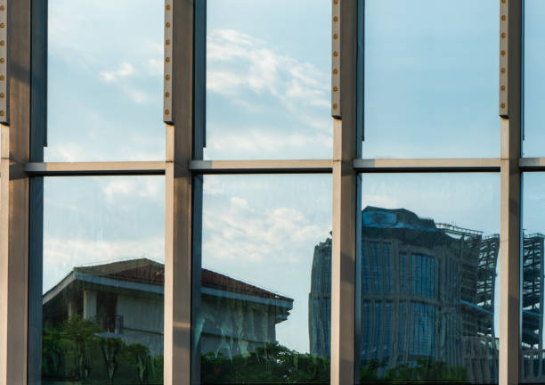 istock A close-up of modern architecture. Blue sky and white clouds are reflected on the glass outer wall 1341216801