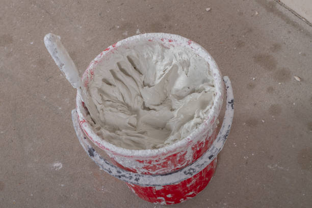 istock Bucket with putty and spatula for wall putty 1341217788
