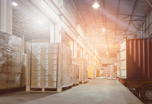 istock Stacked of Package Boxes on Pallets Loading with Shipping Cargo Container. Truck Parked Loading at Dock Warehouse. Delivery. Warehouse Logistics. Cargo Freight Truck Transportation. 1341219979