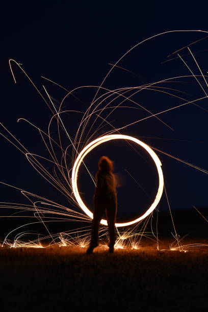 istock Iron wool circle drawing light fireworks. Burning Steel Wool spinning, Trajectories of burning sparks at night. Movement light effect, steel wool fire hoop. long exposure light painting, Pyrotechnic 1341220301