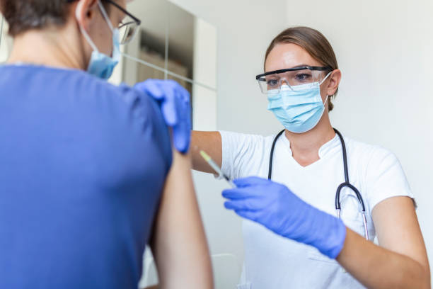 istock General practitioner vaccinating old patient in clinic with copy space. Doctor giving injection to senior man at hospital. Nurse holding syringe before giving Covid-19 or coronavirus vaccine. 1341221170