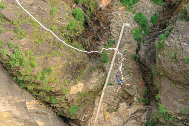 Bungee jumping of Verzasca dam Verzasca, Switzerland - June 2021: Bungee jumping of Verzasca dam on Vogorno lake of Switzerland. location of James Bond movies in Ticino. Highest Bungee jumping of Europe. vogorno stock pictures, royalty-free photos & images