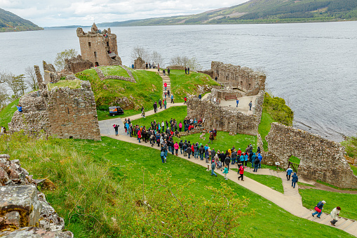 Loch Ness, Scotland, United Kingdom - May 24, 2015: tourists visiting Urquhart Castle beside Loch Ness lake. Visited for the legend of the Loch Ness monster: Nessie.