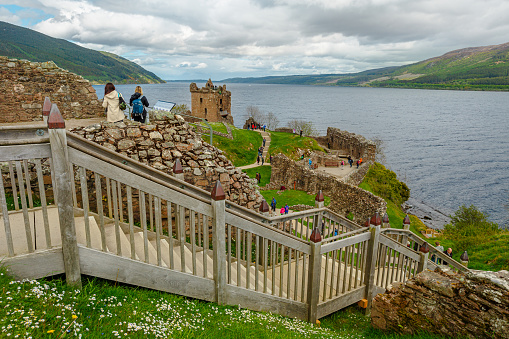 Loch Ness, Scotland, United Kingdom - May 24, 2015: tourist people on the strairway of Urquhart Castle beside Loch Ness lake. Visited for the legend of the Loch Ness monster: Nessie.
