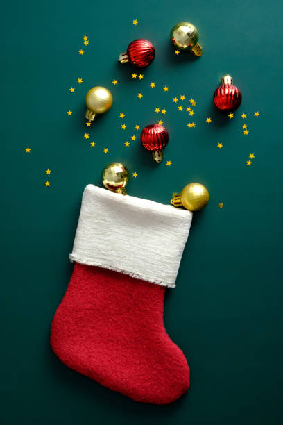 istock Christmas Stocking with decorations on green table. Flat lay, top view. 1341226666