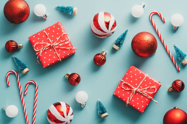 istock Vintage Christmas composition. Flat lay red and white Xmas ornaments and decorations on blue background. 1341226996