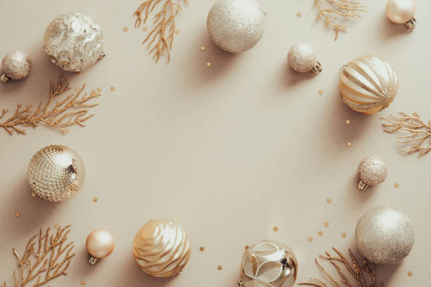 istock Christmas frame with golden balls and Xmas tree branches on beige background. Flat lay, top view, copy space. 1341227218