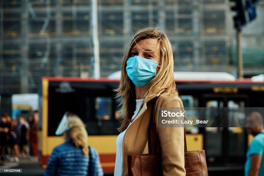 Woman In Protective Mask Walks At City Street Photo taken in Wroclaw, Poland Coronavirus Stock Photo