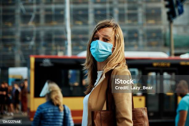 Woman In Protective Mask Walks At City Street Stock Photo - Download Image Now - Coronavirus, Protective Face Mask, COVID-19