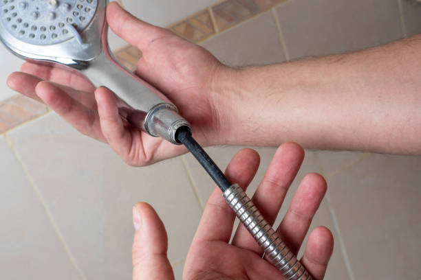 istock Broken chrome shower hose in men's hands. Rift, rubber, selective focus, shower equipment 1341228704