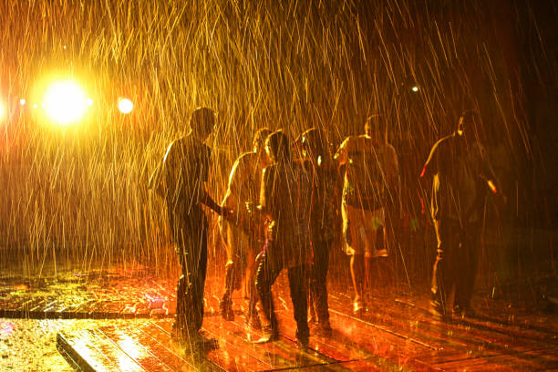 regentanz - happy men rain water dance stock-fotos und bilder