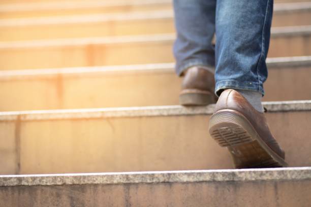istock Business man going up the stairs in a rush hour to work. Hurry time. 1341233075