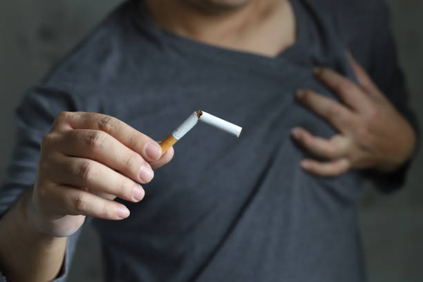 A man quit smoking due to chest pain and health problems. stock photo