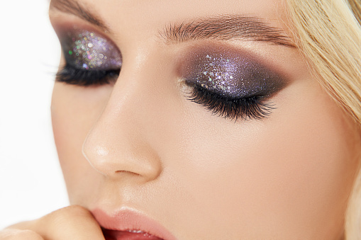 Closeup shot of woman eye with evening makeup. Long eyelashes. Smokey Eyes. Studio shot