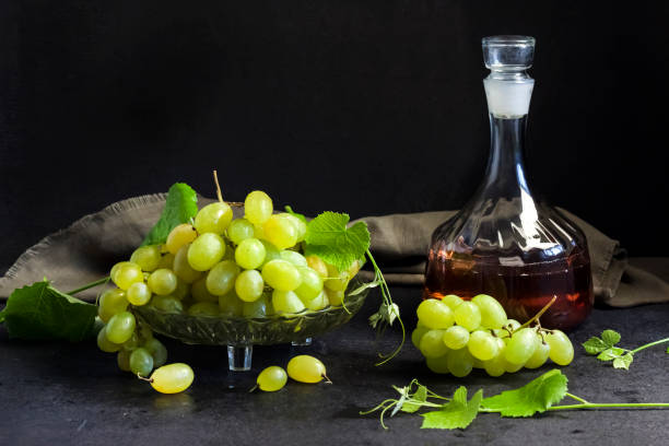 istock Fresh ripe grapes and decanter with grape juice on black background 1341235922