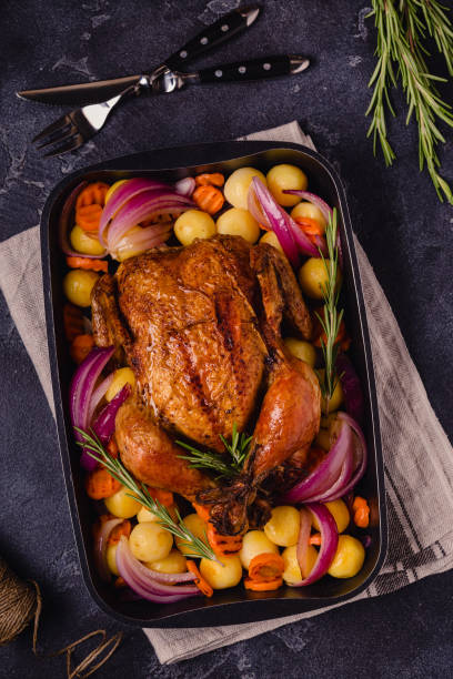 istock Whole baked chicken with vegetables 1341236826