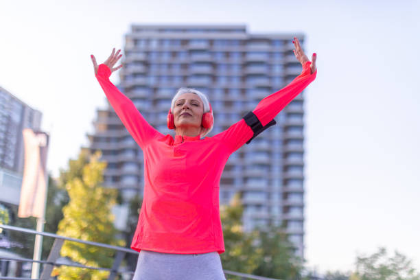 istock Senior athletic woman stretching outside 1341237772
