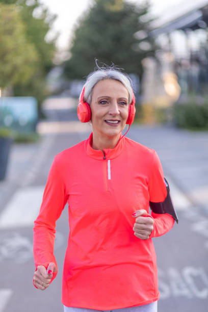 istock Senior athletic woman jogging outside 1341237817