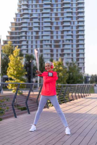 istock Senior athletic woman stretching outside 1341237823